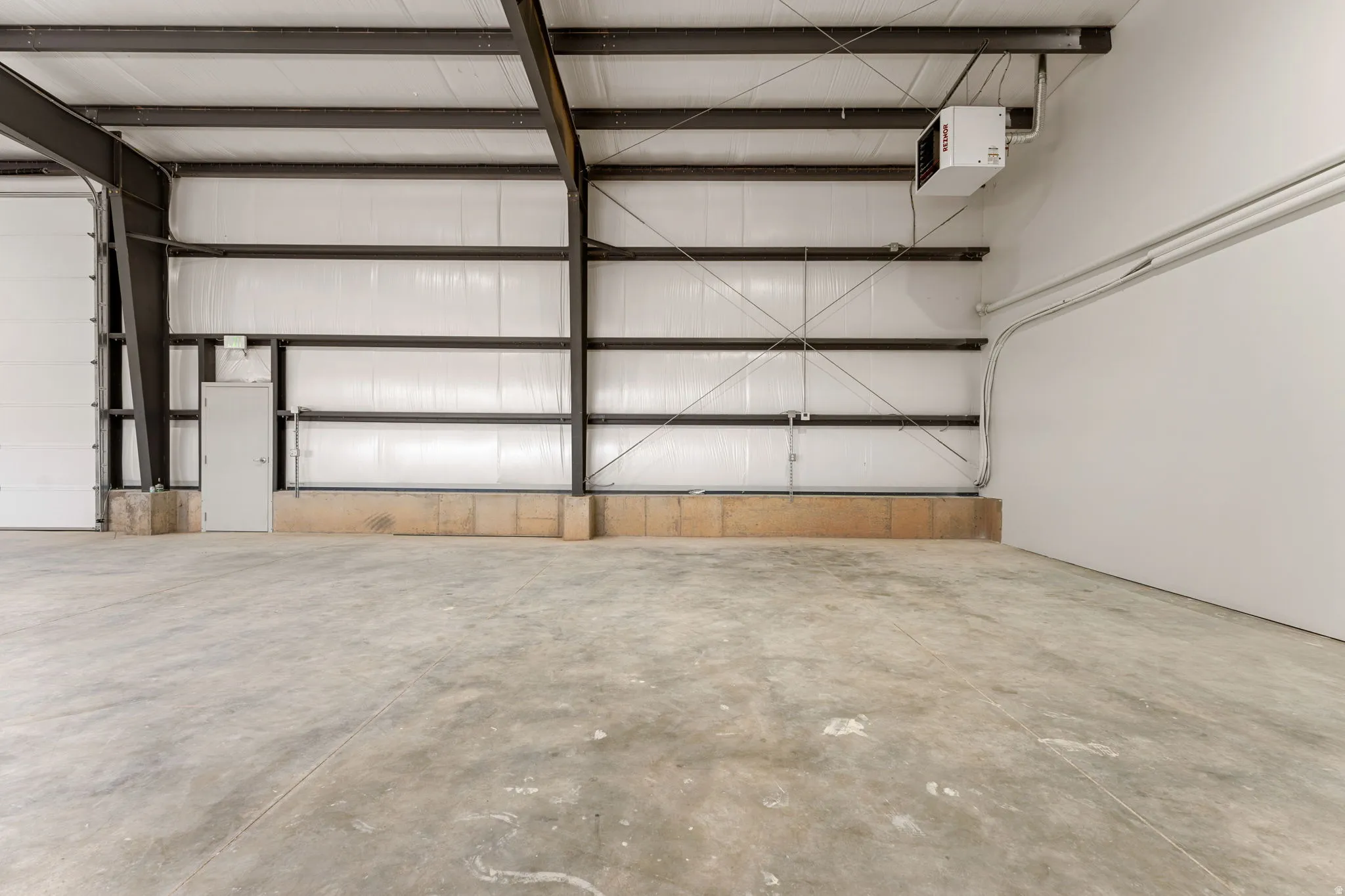 Garage featuring a heating unit