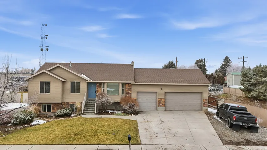 Ranch-style home featuring a shingled roof, concrete driveway, and a garage