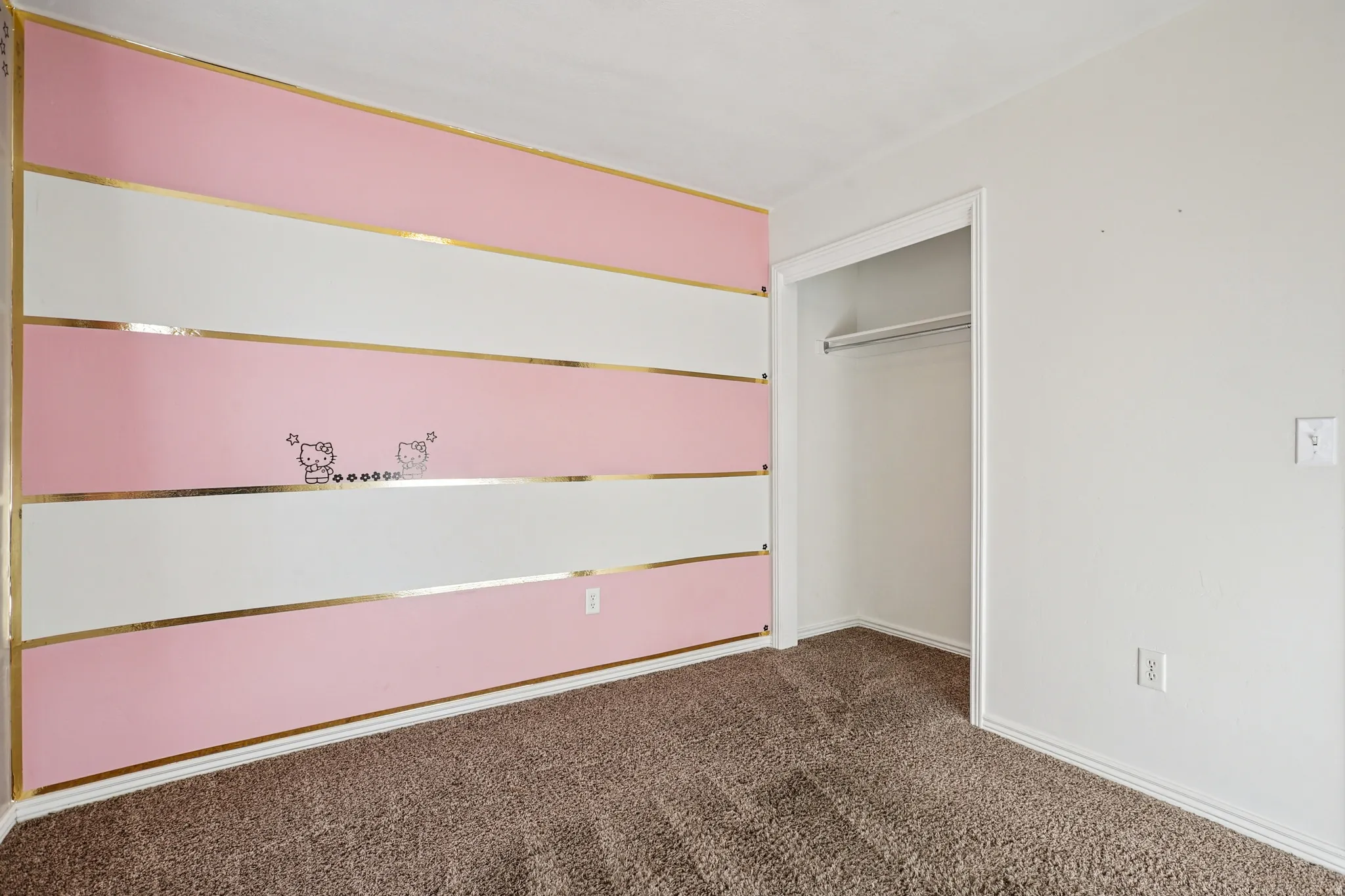 Unfurnished bedroom featuring dark colored carpet and a closet