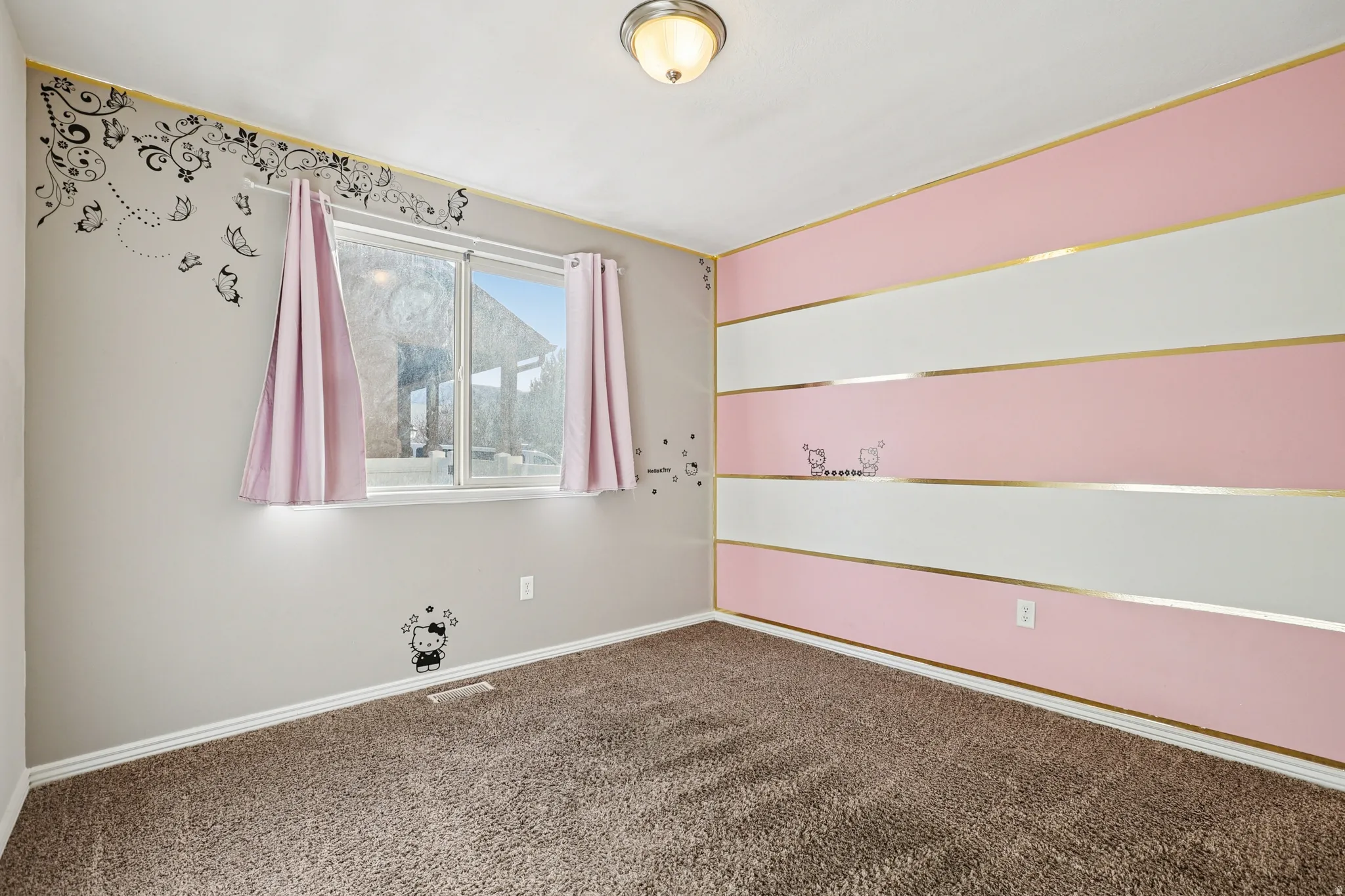 Spare room featuring carpet flooring and baseboards
