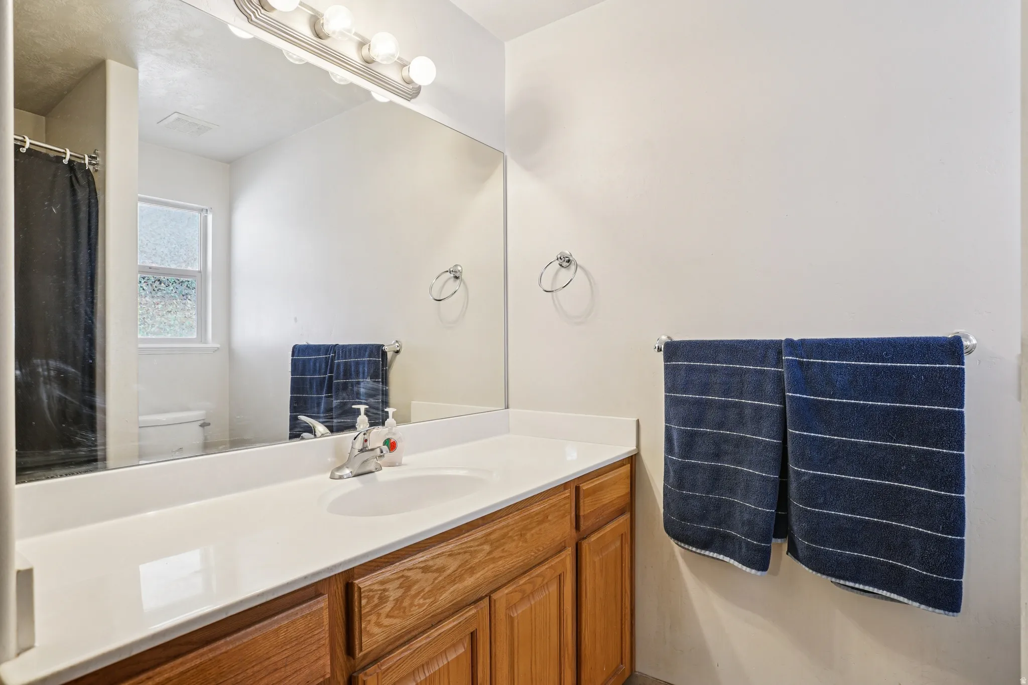 Full bathroom featuring vanity and curtained shower