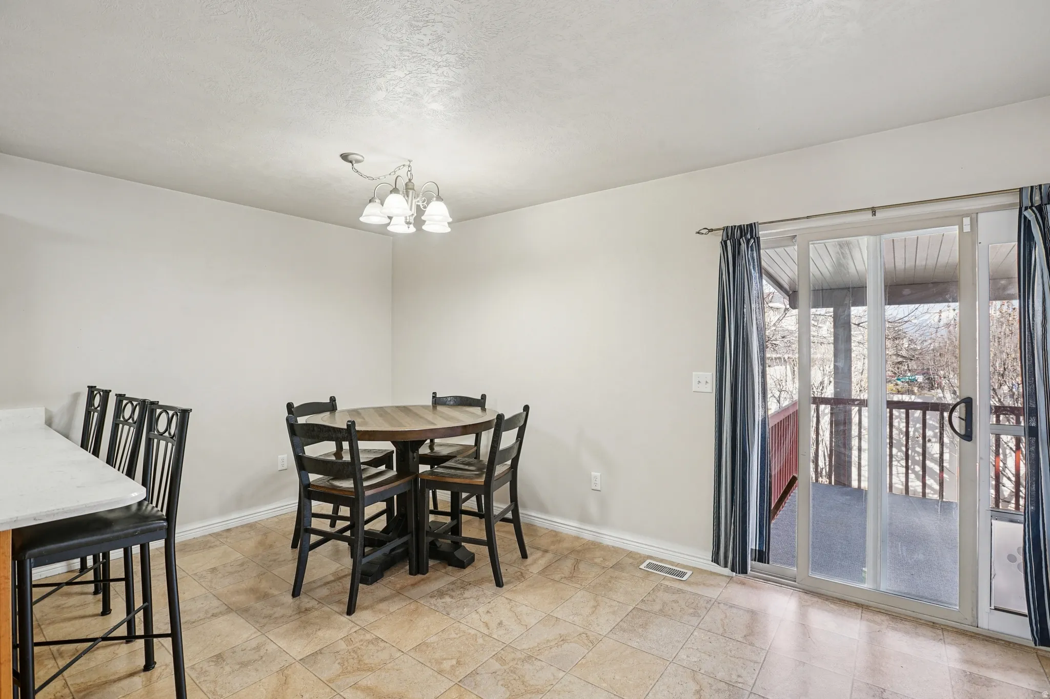 Dining area with baseboards and a chandelier