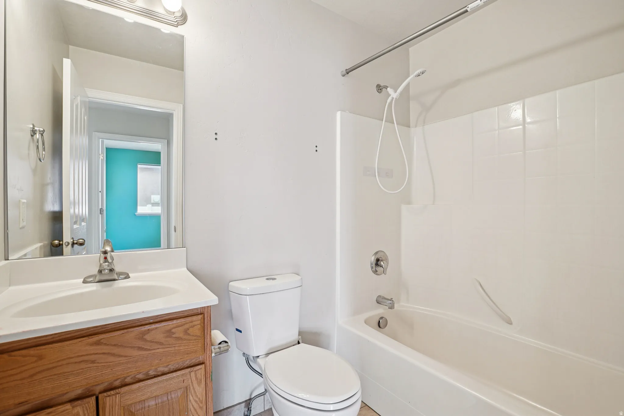Bathroom featuring washtub / shower combination and vanity