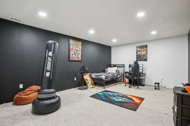 Carpeted bedroom with recessed lighting