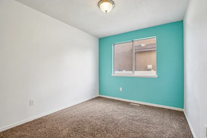Carpeted spare room with baseboards and a textured ceiling