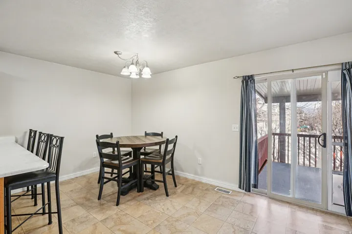 Dining area with baseboards and a chandelier