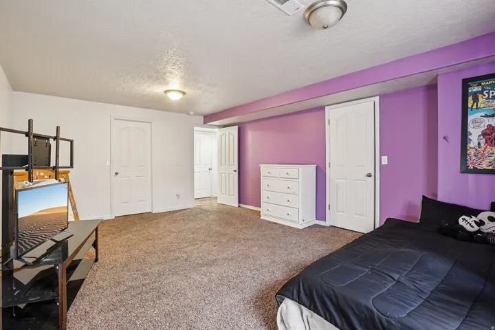 Bedroom featuring carpet floors and a textured ceiling