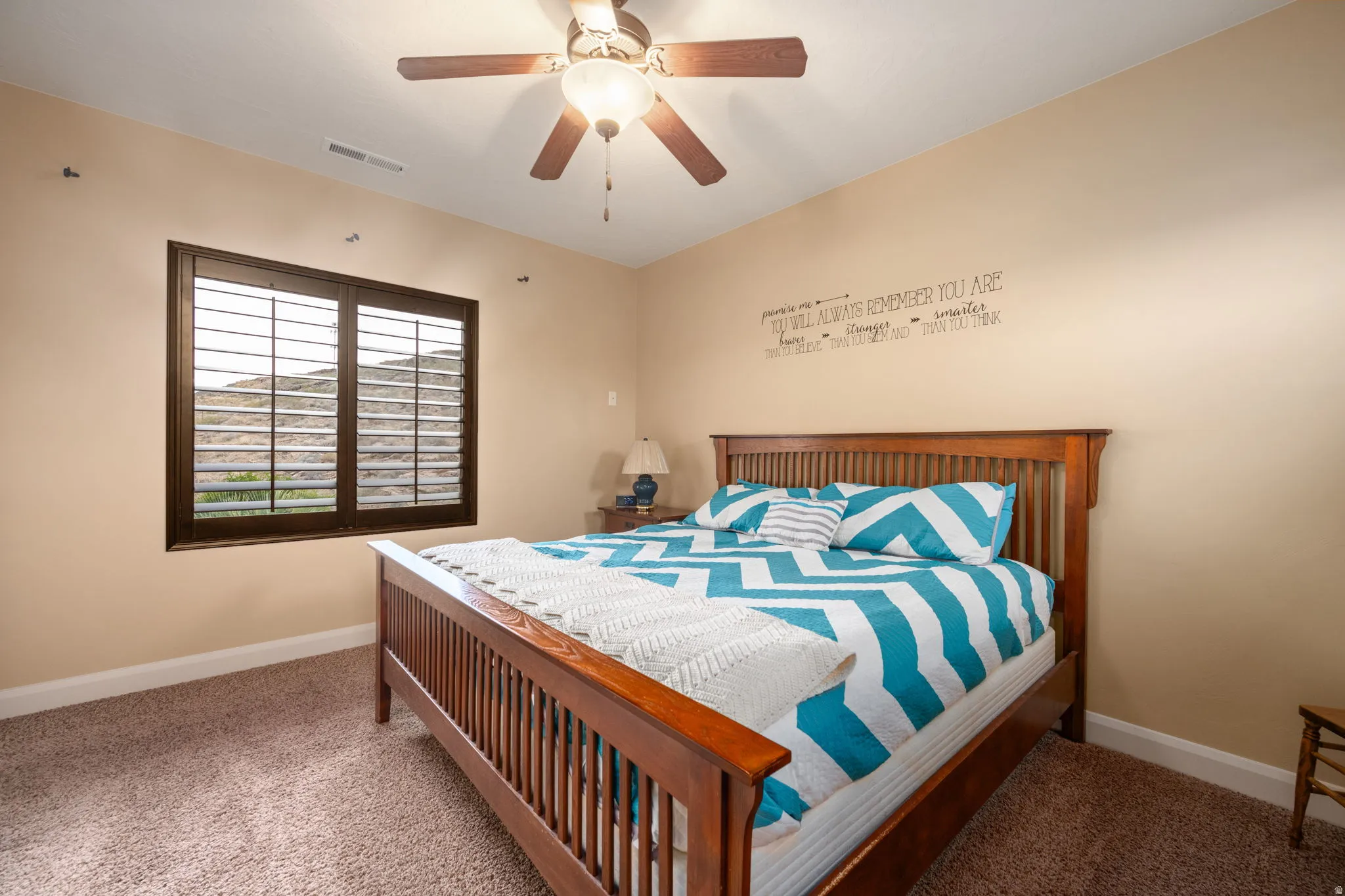 Carpeted bedroom with baseboards and ceiling fan