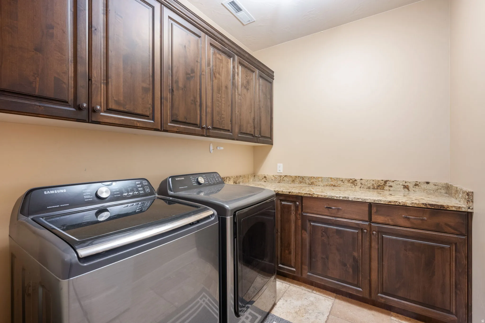 Laundry area with cabinet space and washer and dryer