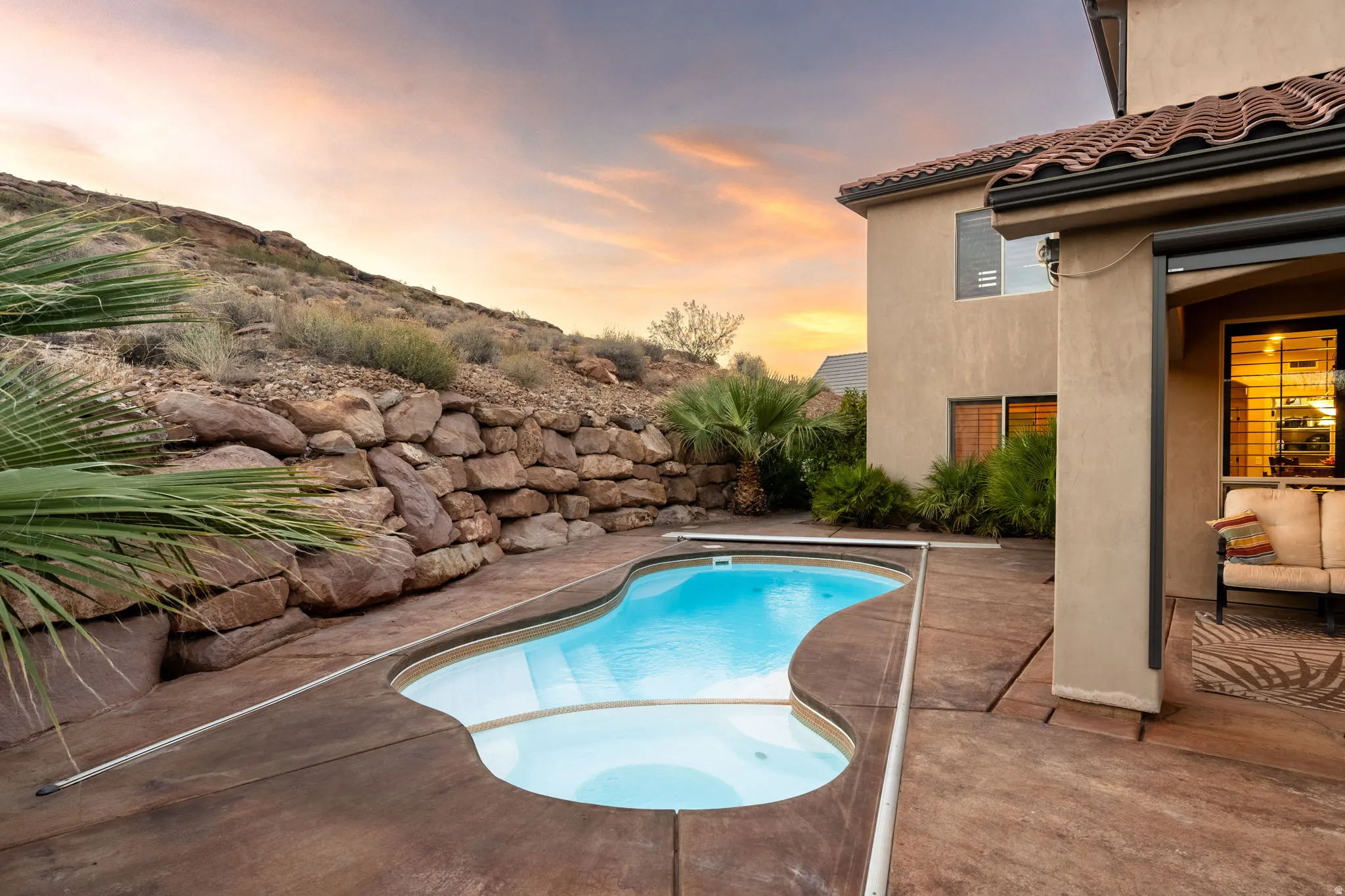 View of swimming pool with a patio area and a pool with connected hot tub