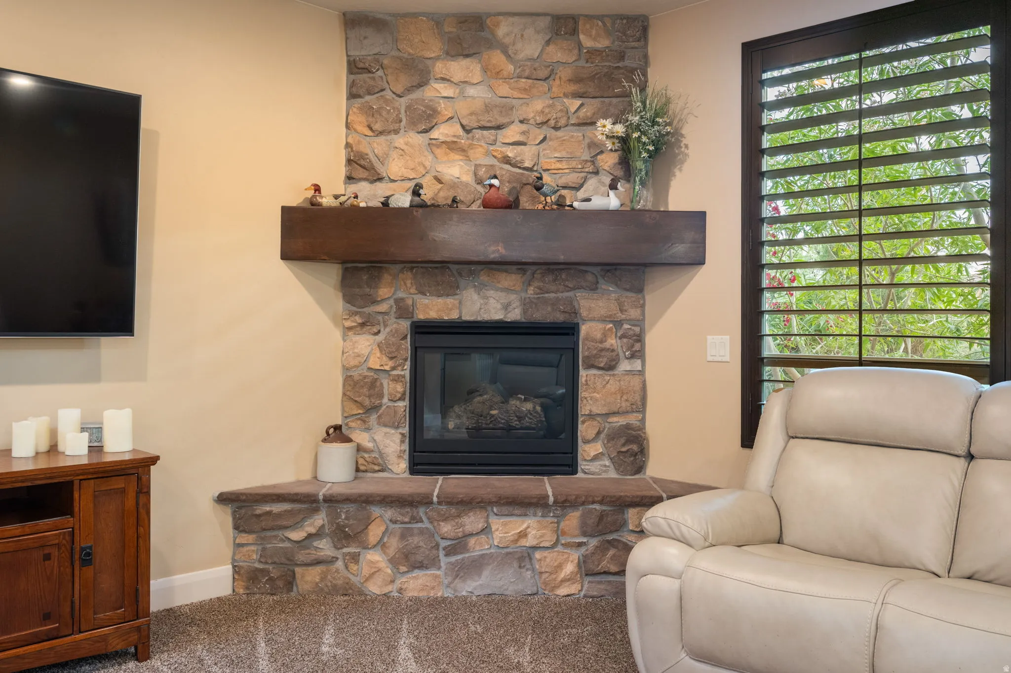 Living room with a fireplace and carpet floors