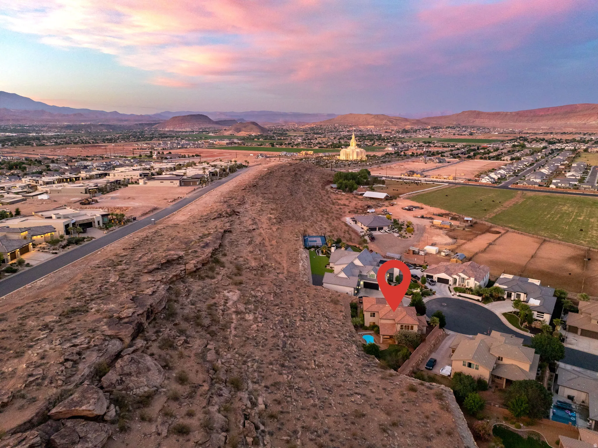 Aerial overview of property's location featuring nearby suburban area and a mountain backdrop