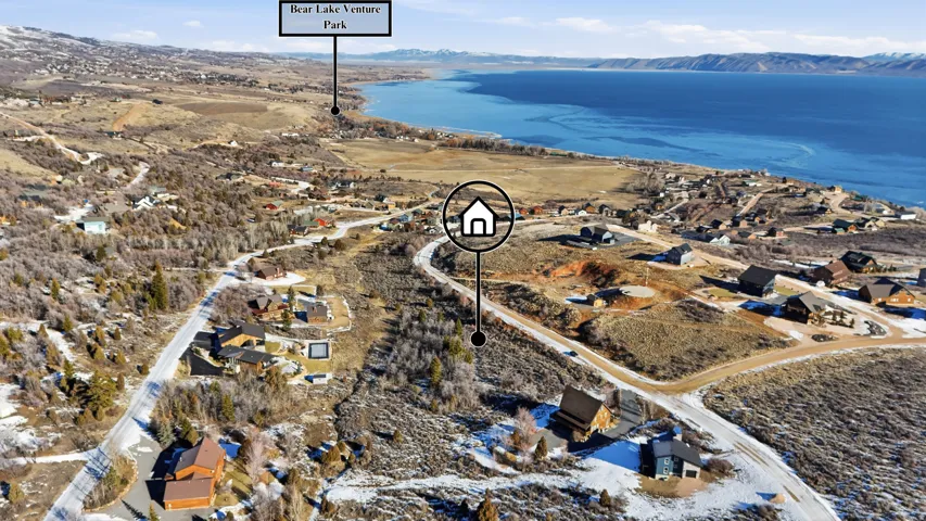 Aerial view of property's location featuring nearby suburban area and a water and mountain view