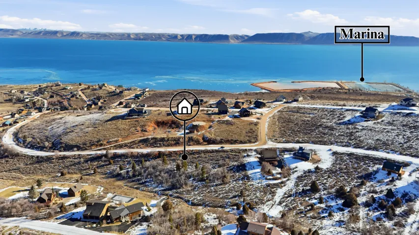 Aerial view of property and surrounding area with a mountain backdrop and nearby suburban area