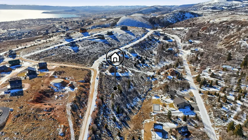 Snowy aerial view with a water and mountain view