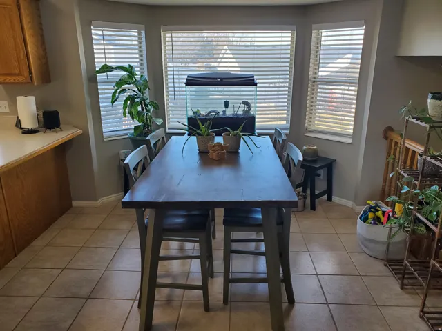 Dining space featuring light tile patterned floors and baseboards