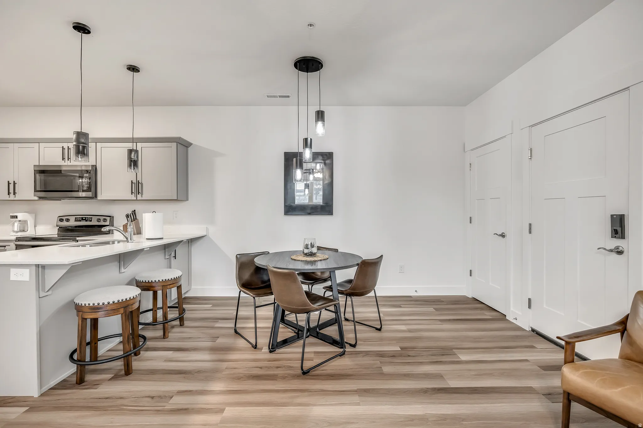 Dining space featuring light wood-style flooring and baseboards