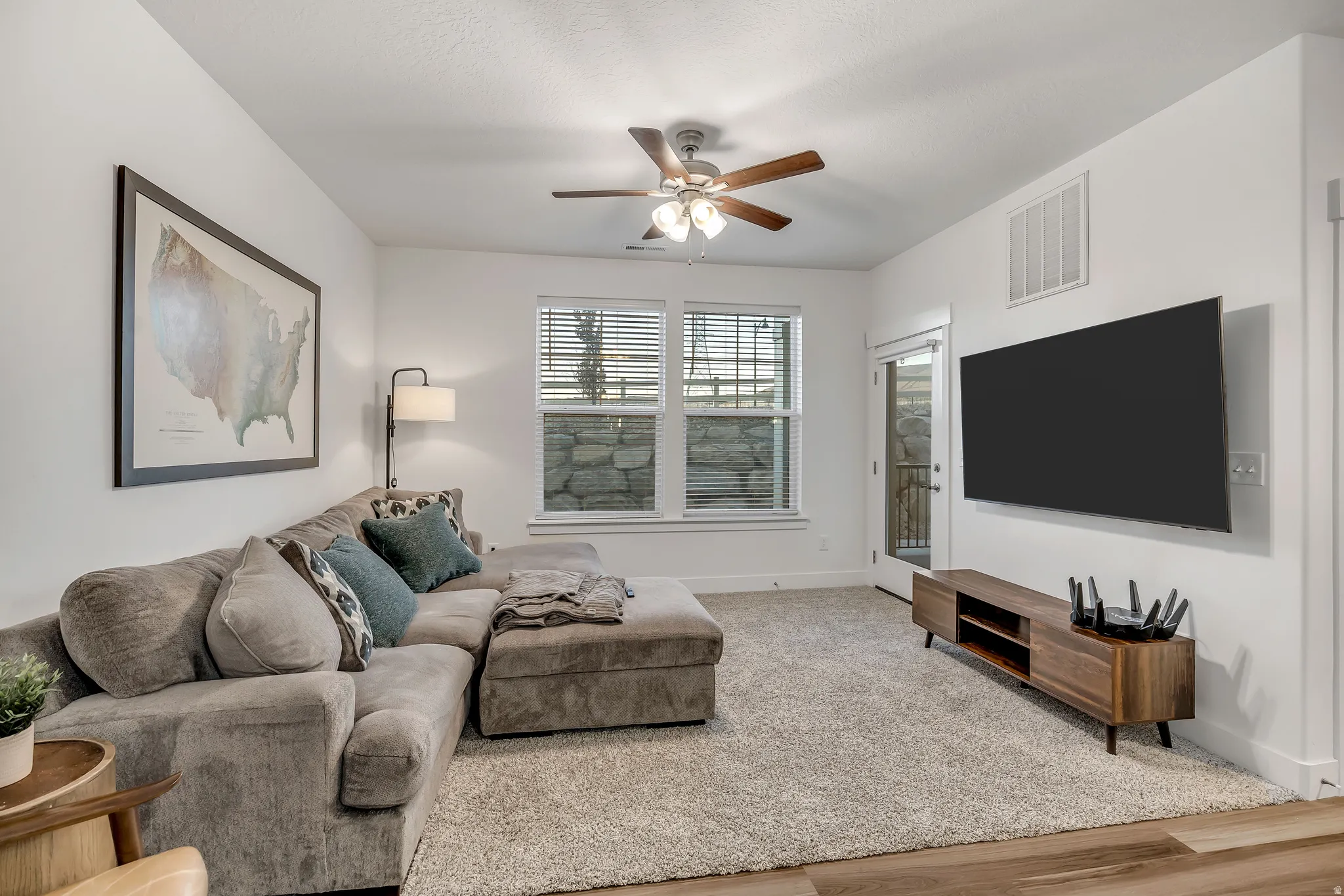 Living room with a ceiling fan and wood finished floors