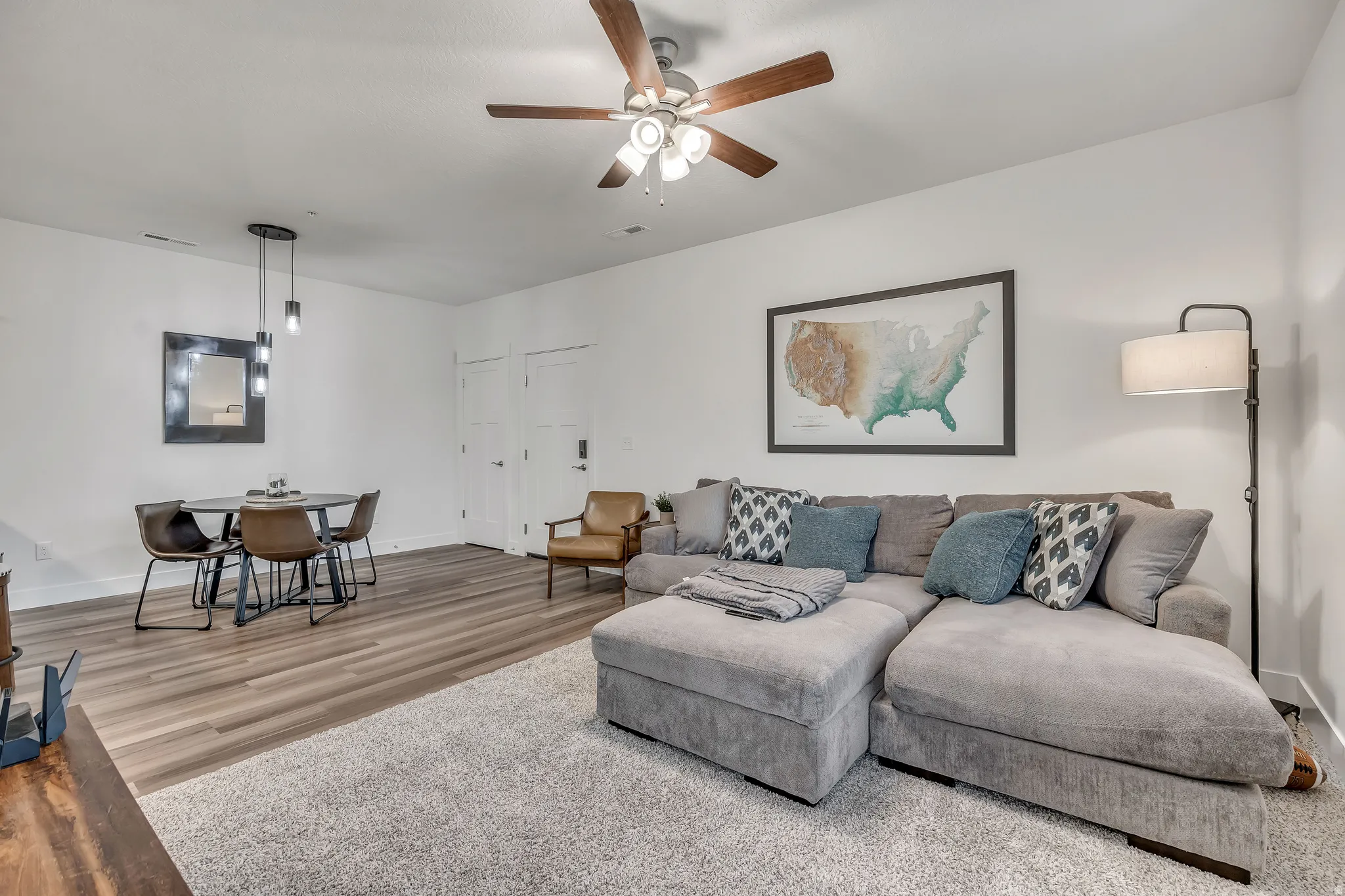 Living room with wood finished floors and a ceiling fan