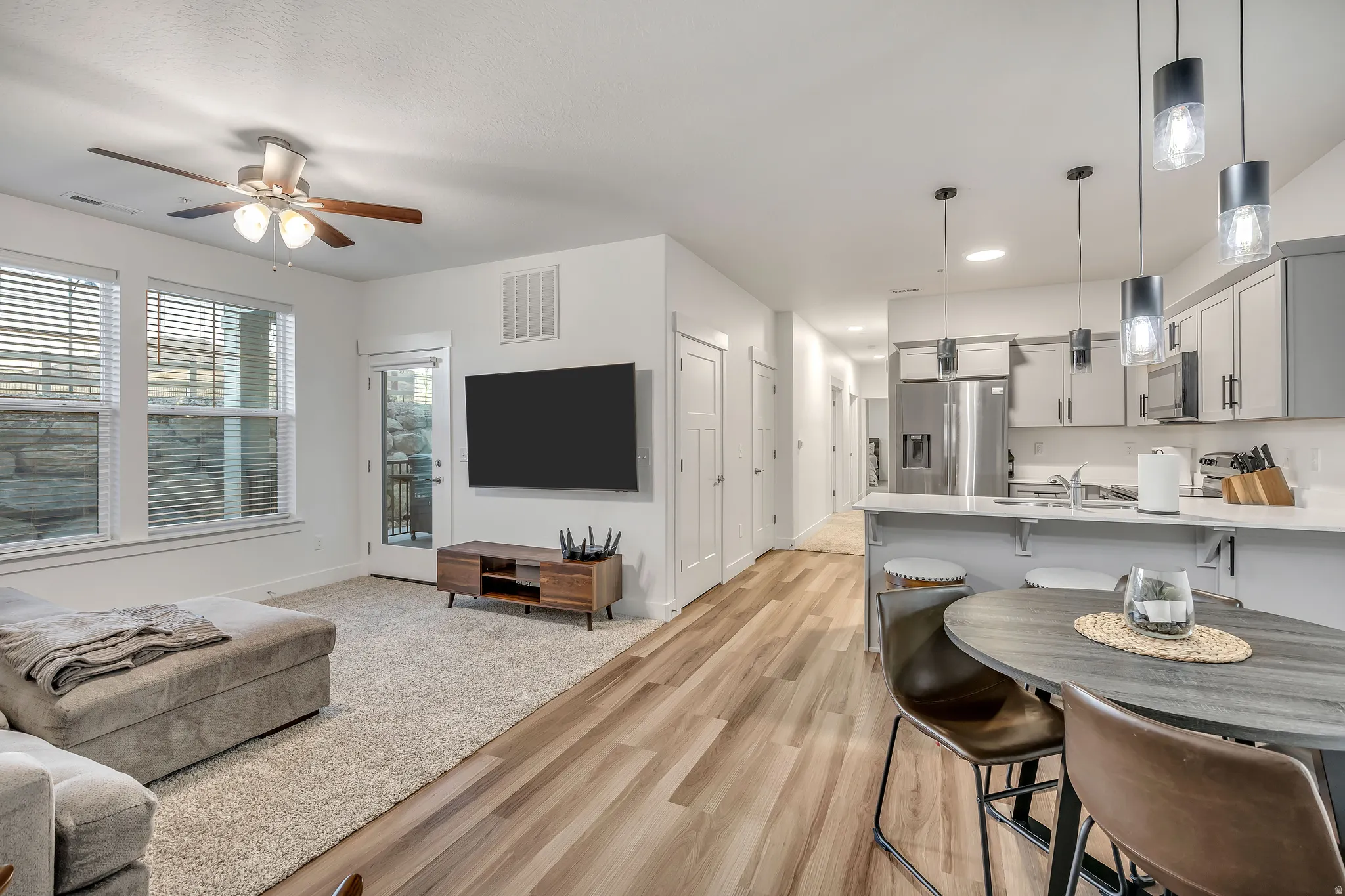 Living room featuring light wood-style floors and a ceiling fan