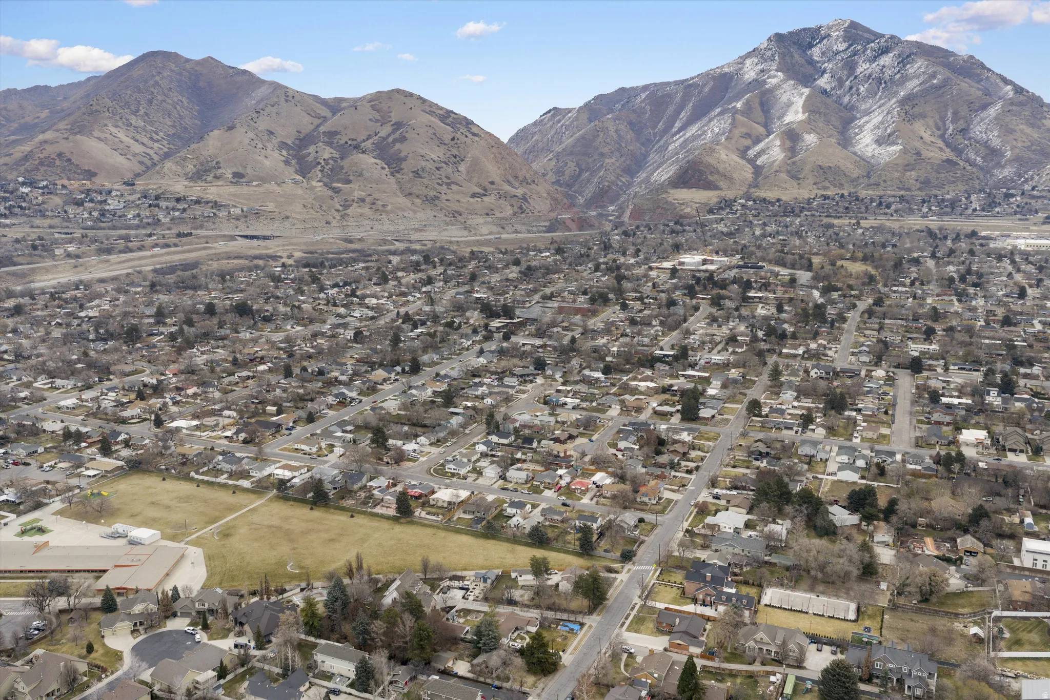 View of mountain backdrop featuring nearby suburban area