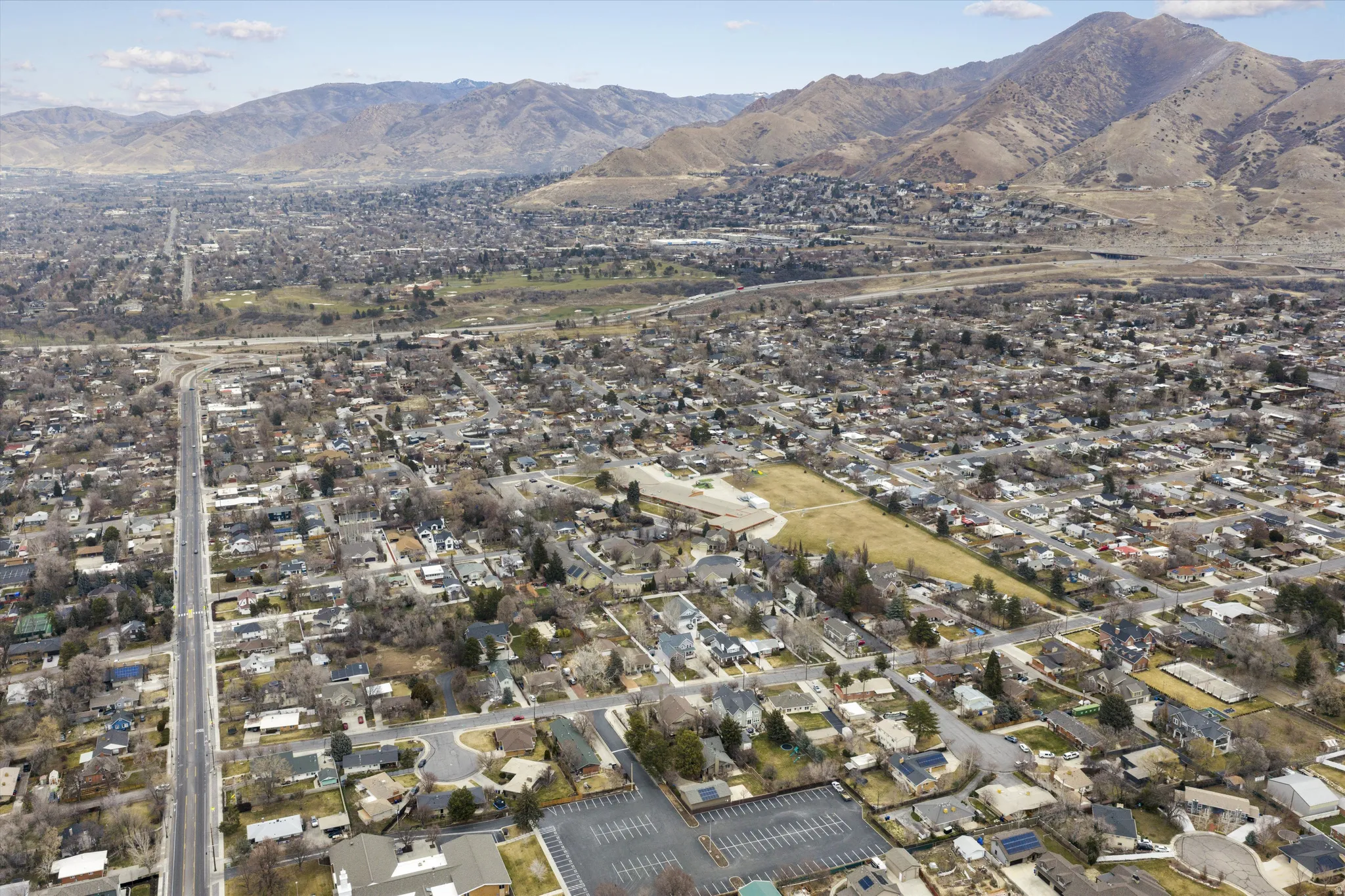Aerial view of property's location with a mountainous background and nearby suburban area