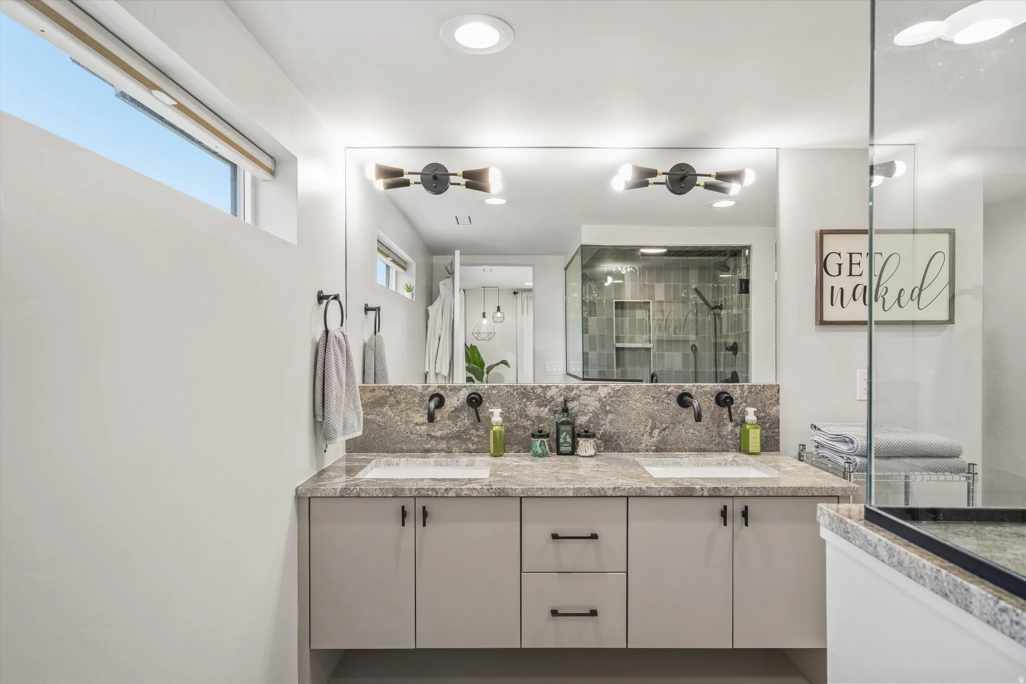 Primary bath with double vanity, decorative backsplash, a stall shower, and recessed lighting