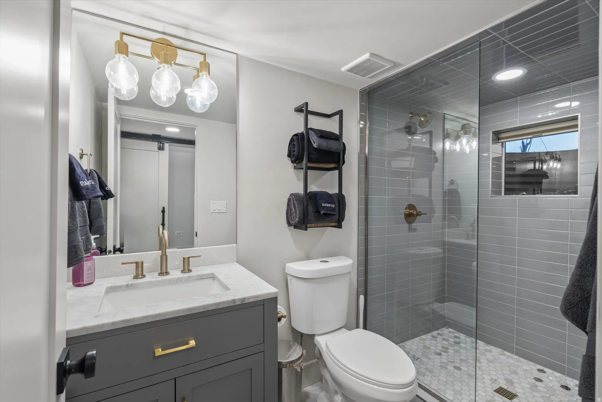 Basement Bathroom featuring a stall shower, vanity, and recessed lighting