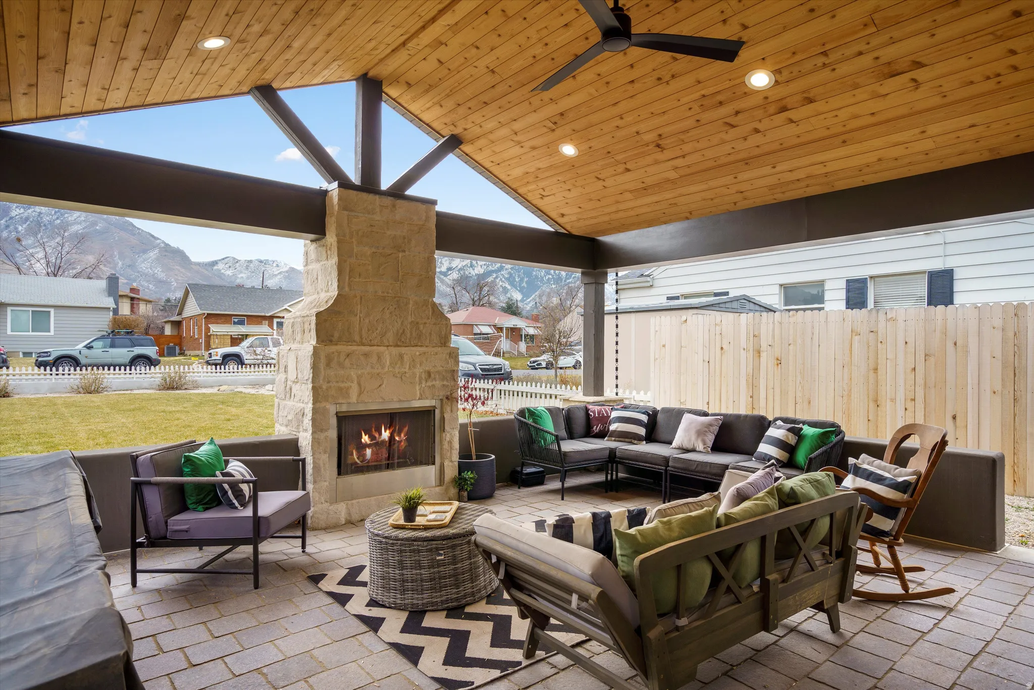 View of patio / terrace featuring an outdoor living space with a fireplace, a mountain view, ceiling fan, and Mountain view