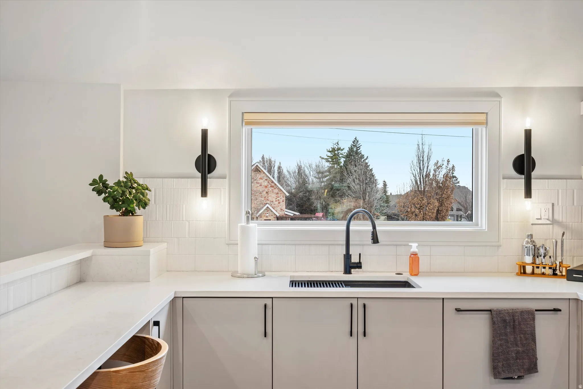 Kitchen with light stone countertops and decorative backsplash