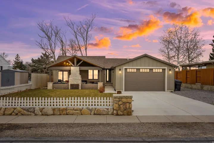 Modern home with driveway, board and batten siding, and an attached garage