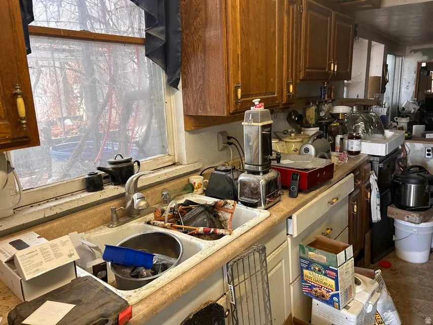 Kitchen with a sink and light countertops