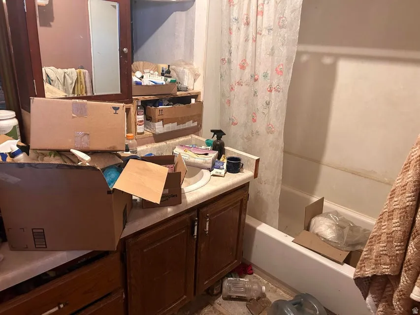 Full bath featuring vanity and shower / bath combination with curtain