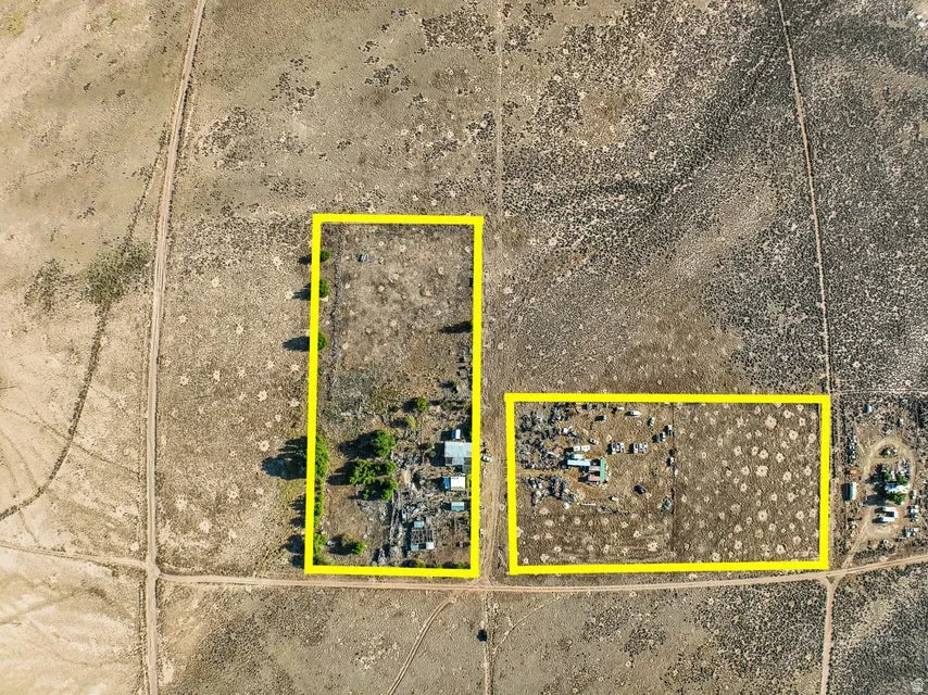 Aerial view of sparsely populated area with property parcel outlined and a desert landscape
