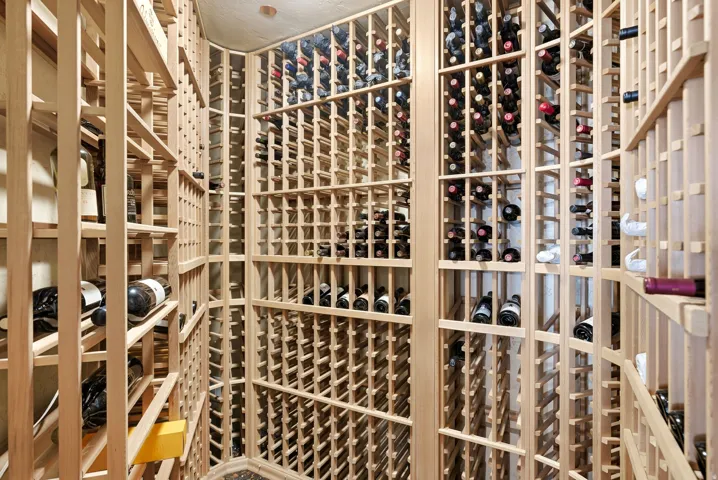 Built-in wood wine racking system in a dedicated storage area