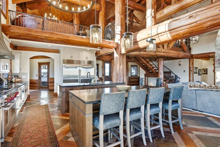 Gourmet kitchen with professional-grade stainless steel appliances, custom cabinetry, and a large center island with seating
