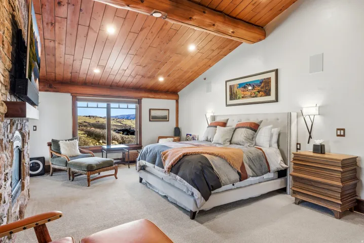Wood-paneled vaulted ceiling with exposed beams