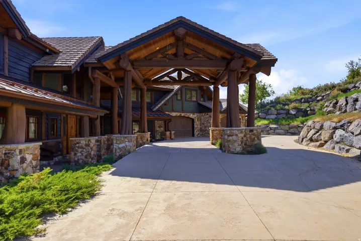 Stone and timber porte-cochère entry with a multi-gabled roofline