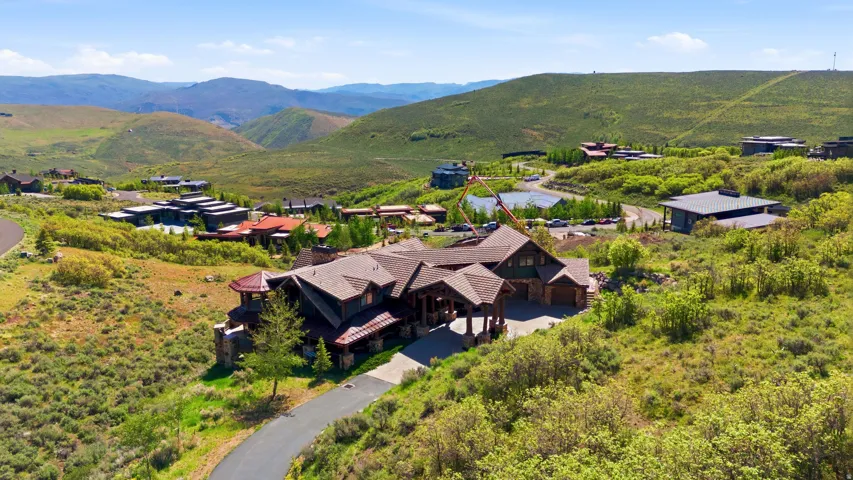 Mountain-style residence featuring a multi-gabled roofline and stone accents