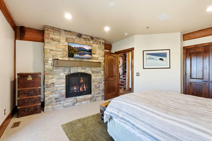 Stone-front fireplace with a substantial wood mantle
