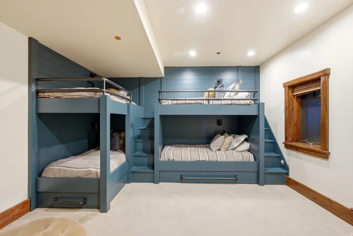 Built-in bunk beds with integrated storage drawers and steps