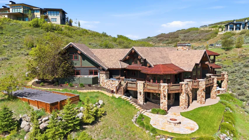 Expansive multi-level deck with stone pillars, wood railings, and a copper-domed rotunda
