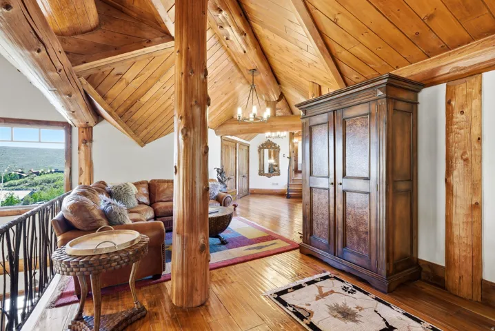 Vaulted wood plank ceiling with exposed log beams