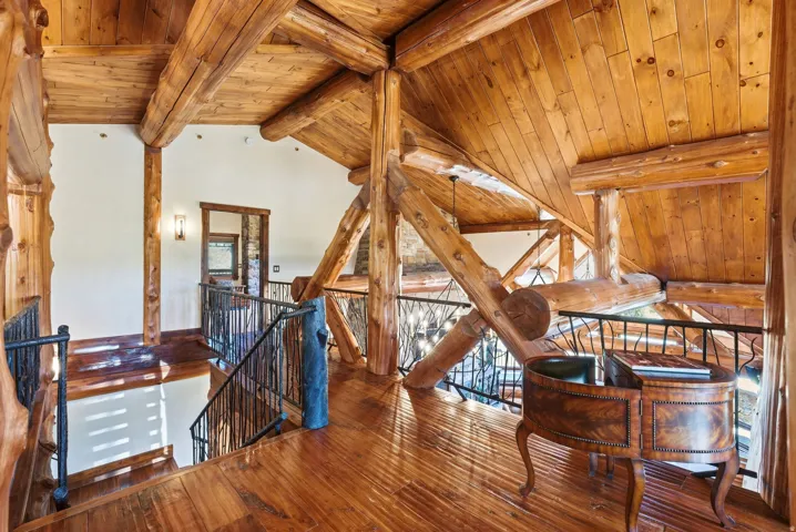 Vaulted ceilings with exposed log beams and wood planking