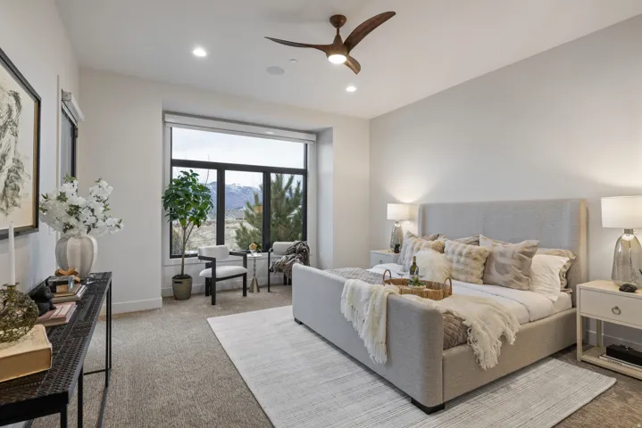 Carpeted bedroom featuring ceiling fan and recessed lighting