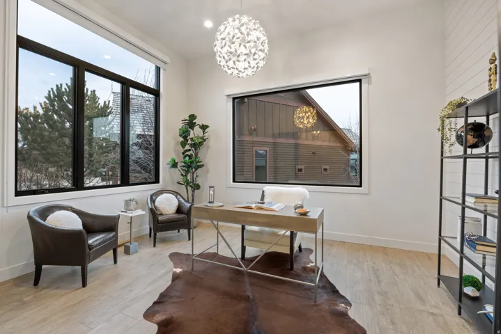 Home office featuring light wood finished floors and a chandelier