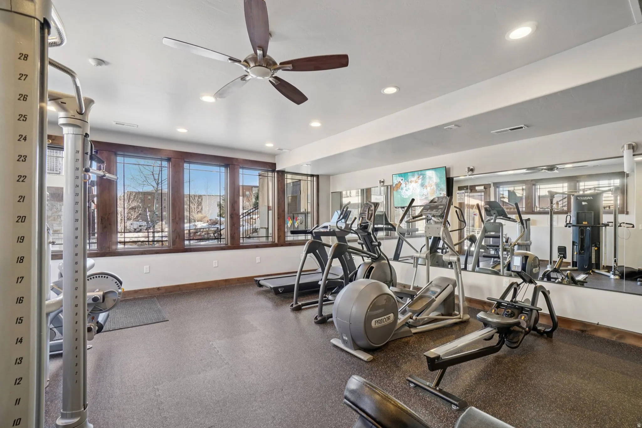 Gym with a ceiling fan and recessed lighting