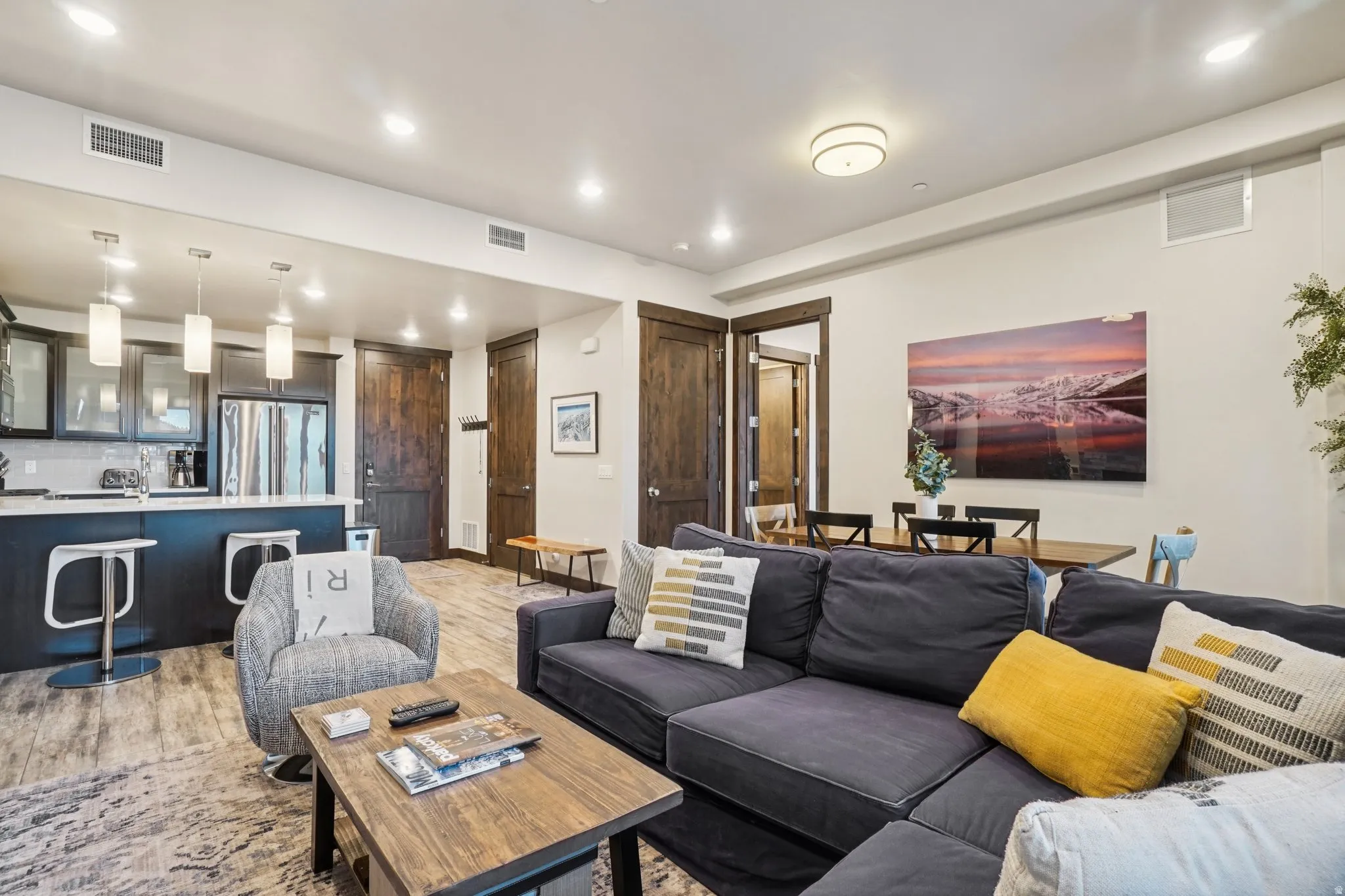Living area with recessed lighting and light wood finished floors