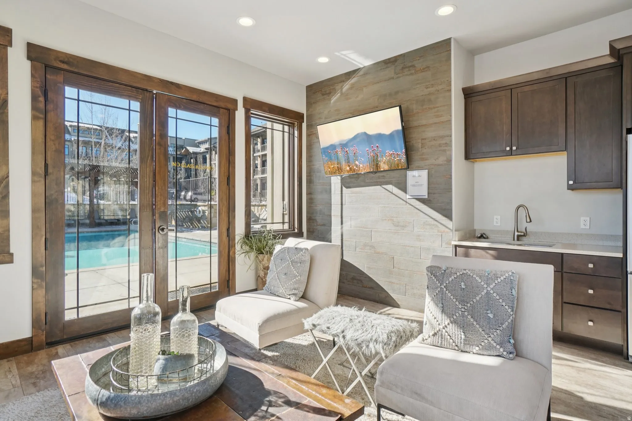 Sitting room with light wood-style floors, recessed lighting, and french doors