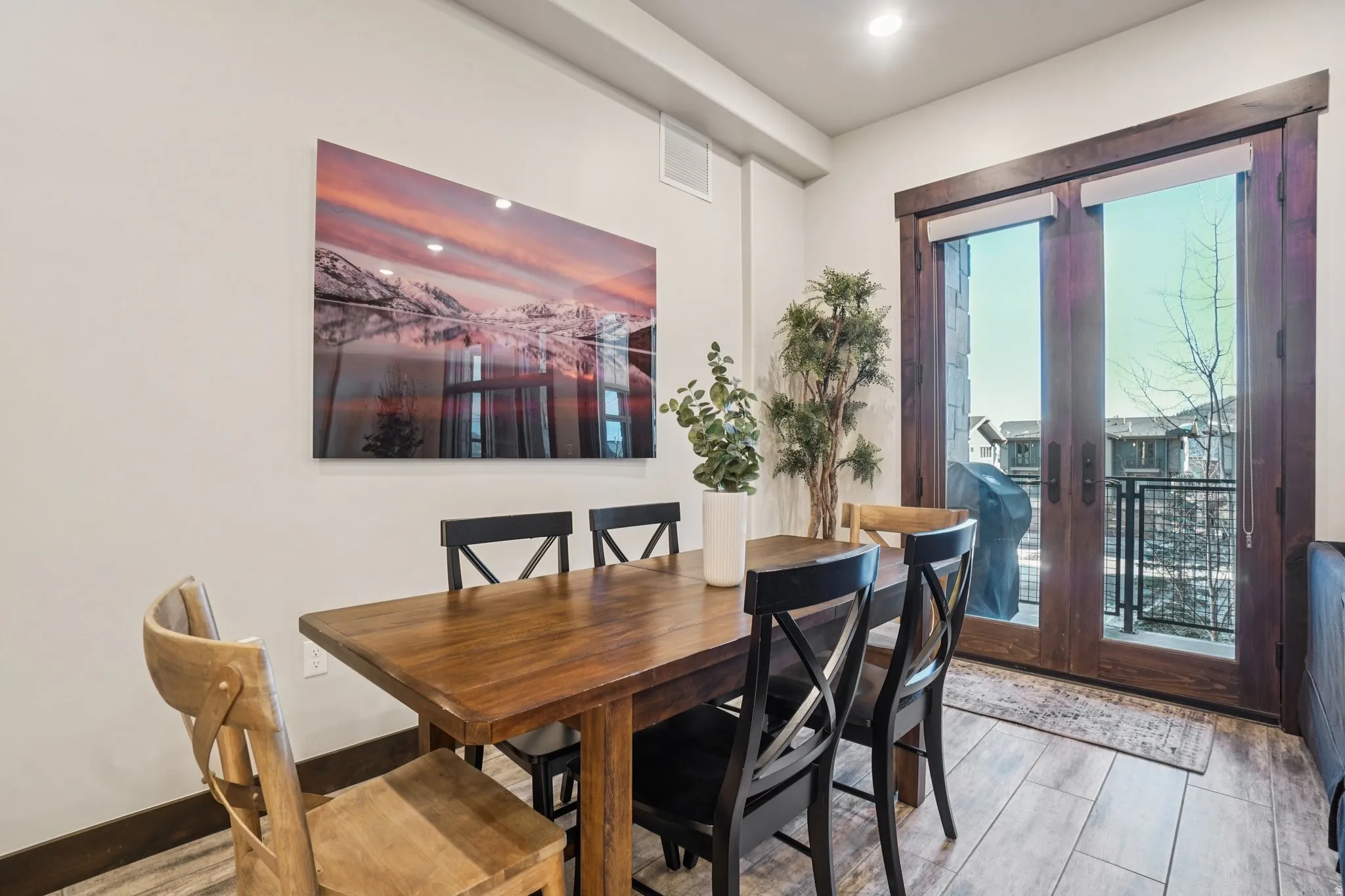 Dining space with french doors and wood finished floors
